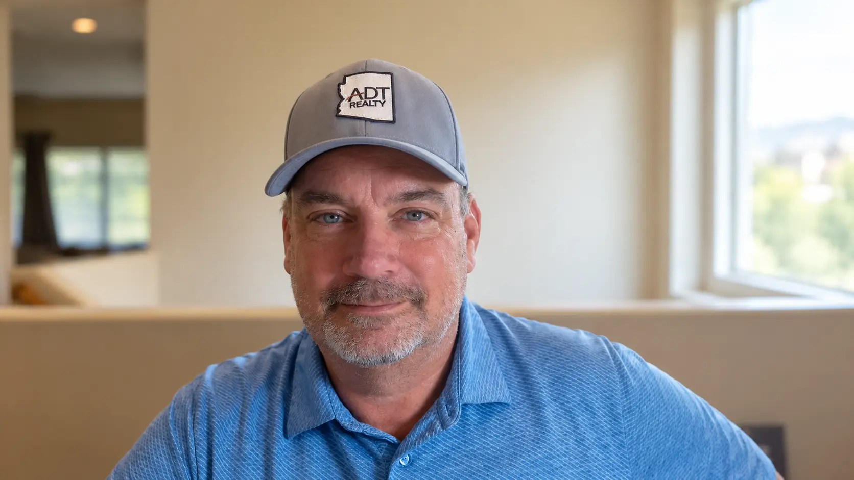 Mike Dingman in an ADT Realty hat